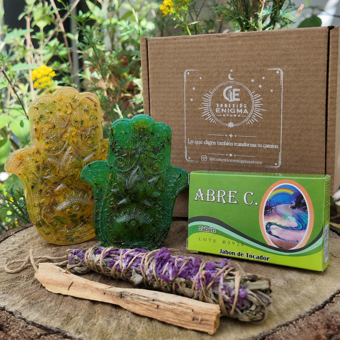 Kit Ritual Renacer con jabón de siete hierbas dulces, jabón de siete hierbas amargas, sahumo de salvia, palo santo y jabón de tocador de obsequio, presentado junto a su caja de Conexión Enigma Store.